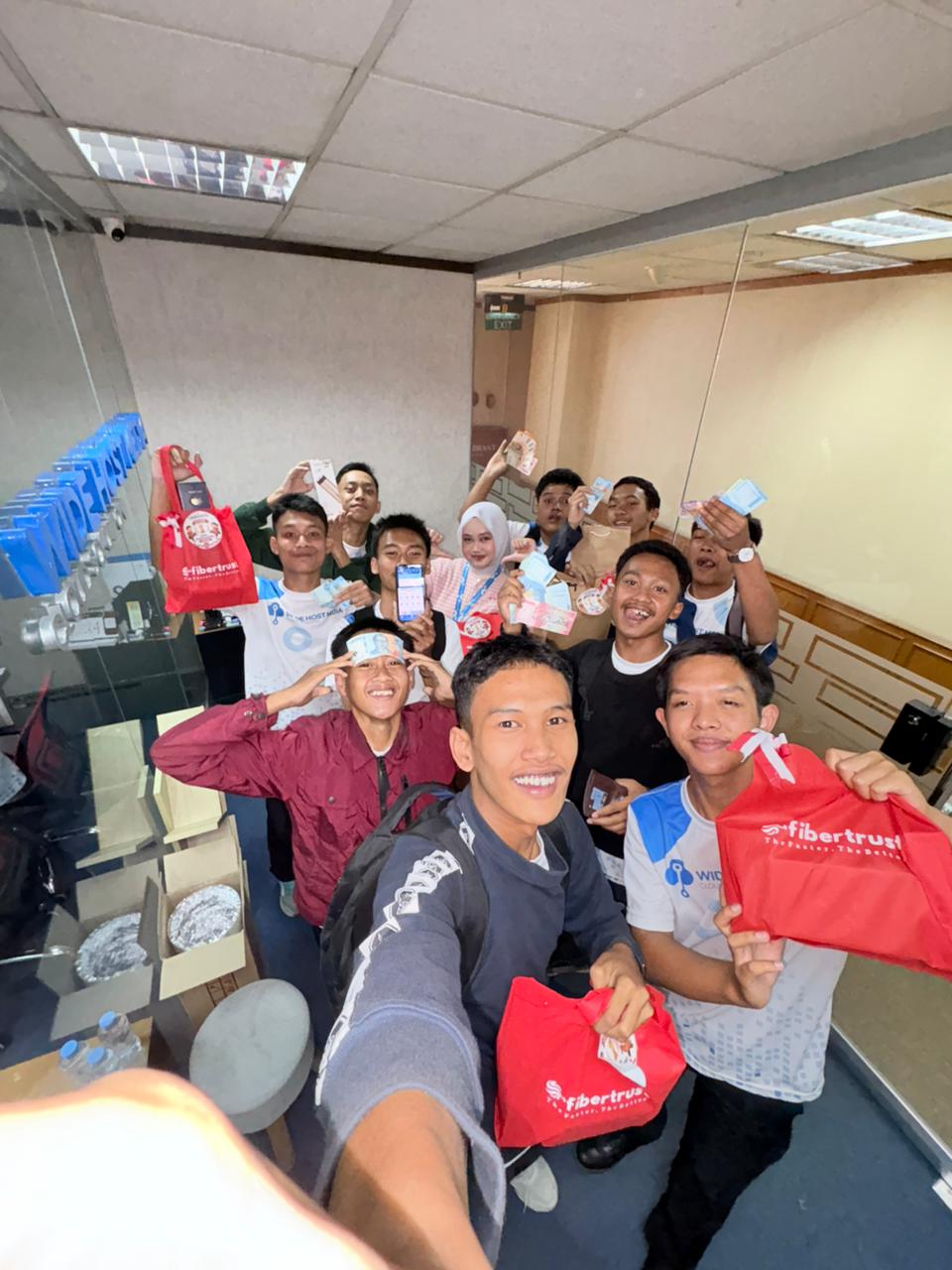 Friends taking a group selfie and holding event souvenirs